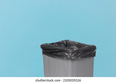 gray trash can lid on blue background	