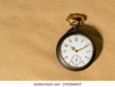 Gray Vintage Pocket Watch With Gold Hands On A Round Dial. Old Retro Clock On A Beige Background With Place For Advertising Or Text, Mockup For Presentation Of Watch Shop .