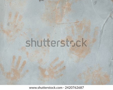 gray wall background with children's scribbles, textured handprints