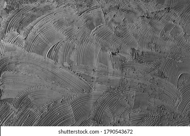 Gray wall glue plaster comb surface prepared for tiling.Tile adhesive notched trowel patterns. Adhesive background. Cement wall - Shutterstock ID 1790543672