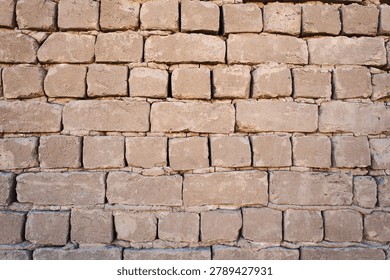 gray wall made of adobe bricks