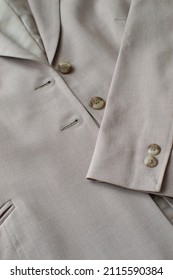 Gray Women's Suit Jacket Is Lying On The Table. Selective Focus. Detail Of A Women's Business Jacket Close-up.