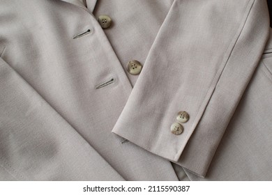 Gray Women's Suit Jacket Is Lying On The Table. Selective Focus. Detail Of A Women's Business Jacket Close-up.