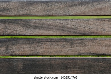 Gray Wood Strips From An Empty Park Bench, Showing The Natural Wood Texture, With Green Grass On The Background