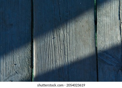 Gray wooden background with vertical lines and autumn ray of sunshine. Board background with copy space. Texture wooden background. High quality photo