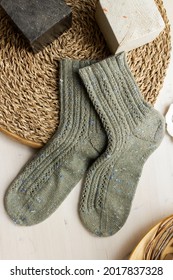 Gray Woolen Knitted Socks On White Wooden Table