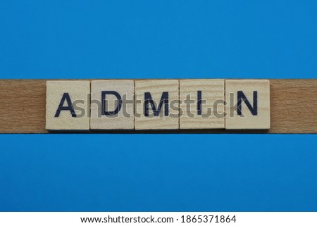 gray word admin in small square wooden letters with black font on a blue background