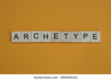 gray word archetype made of wooden square letters on brown background