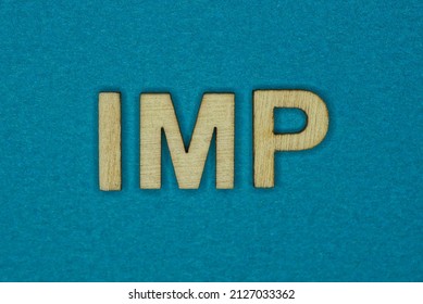 gray word imp in small wooden letters on a blue background
