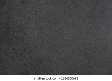 Gray-black Granite Countertop Texture. Black Background With Splashes Of Shiny Pebbles.