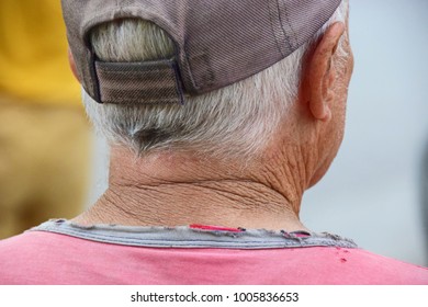 Gray-haired old man with cap