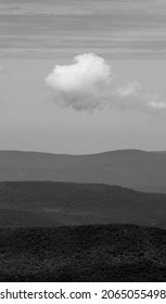 A grayscale of clouds over mountain layer