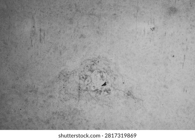 Grayscale concrete texture with subtle variations and markings.
