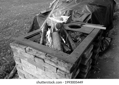 A grayscale high angle shot of a burning fire outdoors