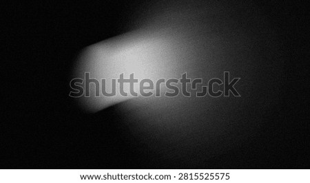 Grayscale image of a comet with bright nucleus and elongated tail against a dark space backdrop, captured with high-contrast lighting.