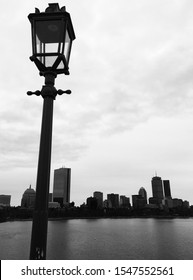 Grayscale lamppost with Boston skyline