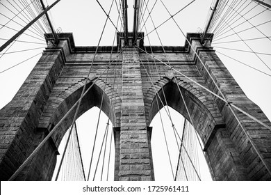 A Grayscale Low Angle Shot Of A Brooklyn Bridge In New York City