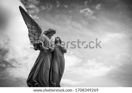 Grayscale Photography Of Angel Statue Under Cloudy Skies