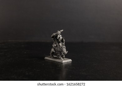 A grayscale selective focus shot of a creature riding a boar figurine