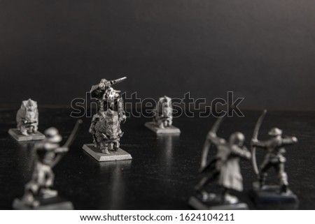 A grayscale selective focus shot of a mythical creature riding a boar figurine