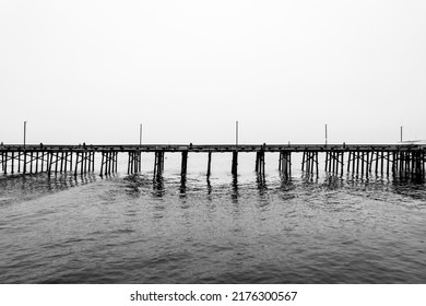 A grayscale shot of a long bridge in Newport Beach, California