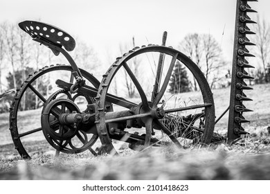 A Grayscale Shot Of An Old Farm Equipment