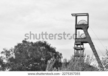 Grayscale shot of the winding tower of an old colliery in Essen, Ruhr area, NRW, Germany.