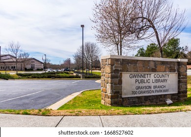 Grayson, GA / USA - March 8 2020: Entrance sign of the Gwinnett County Public Library Grayson Division, at 700 Grayson Parkway. The building is in the background to the left