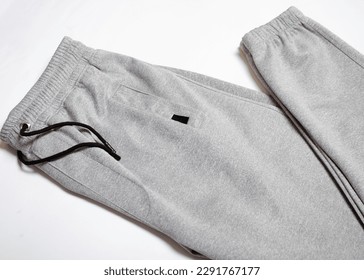 GraySport Sweatpants Isolated on White Background. Folded Gray pants
				
