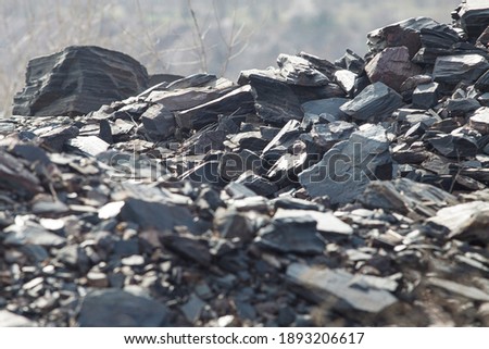 Graystone debris in a slide on a sunny day