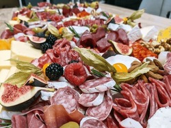 Grazing Table Containing Cured Meats, Charcuterie, Cheese And Fruit