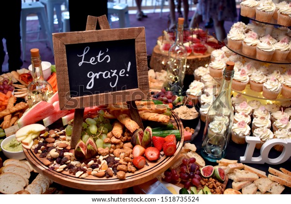 Grazing table at a party with\
sign