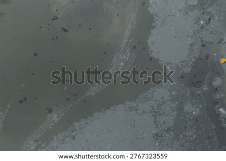 Grease and various types of dirt float on the surface of the polluted public canals, turning the water black.