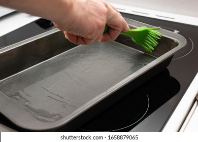 greasing baking sheet with oil. Cooking a cake tin