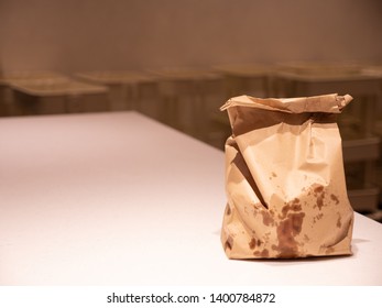 Greasy Brown Paper Bag On The Table