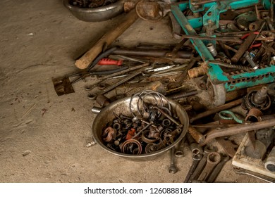 Greasy Tools On Dirty Concrete Floor. Messy Garage