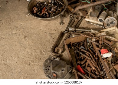 Greasy Tools On Dirty Concrete Floor. Messy Garage