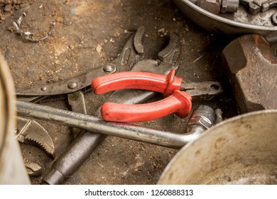 Greasy Tools On Dirty Concrete Floor. Messy Garage