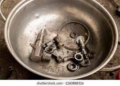 Greasy Tools On Dirty Concrete Floor. Messy Garage