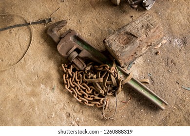 Greasy Tools On Dirty Concrete Floor. Messy Garage