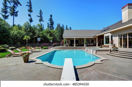 Great Backyard With Swimming Pool And Lounge Chairs In American Suburban Luxury House. Northwest, USA