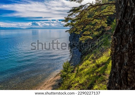 Great Baikal Trail. Popular route along lake Baikal shore from Listvyanka to Big Koty. Lake Baikal coast, hill with forest, water bay. Summer travel, discovery of beauty of Earth. Siberia, Russia.