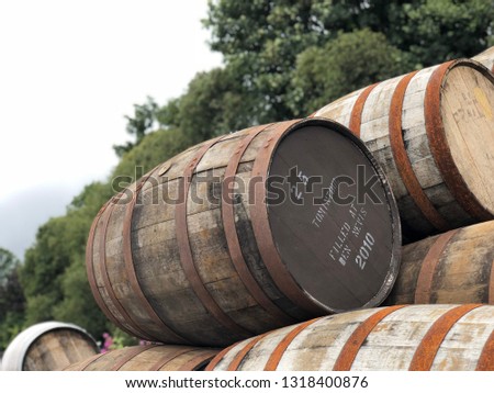 great Ben Nevis Scotish whiskey barrels portrait with trees and scotish nature background