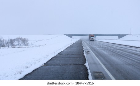 Great Bend, North Dakota / United States - October 25 2020: a passing truck on a rural highway during a snow storm