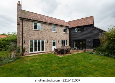 Great Bradley, Suffolk, England - May 19 2017: Detached Brick House With Landscaped Garden, Lawn And Patio