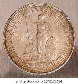 Great Britain British silver coin 1 one trade dollar 1899, face value in Chinese and Arabic within oriental ornaments, standing Britannia with oval shield and trident, sailing ship, on digital scales.
