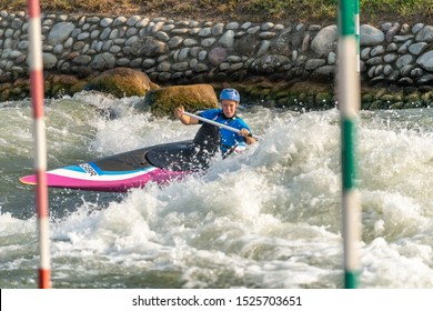 Great Britain Canoe Slalom Athlete Training On White Water With Poles In The Foreground