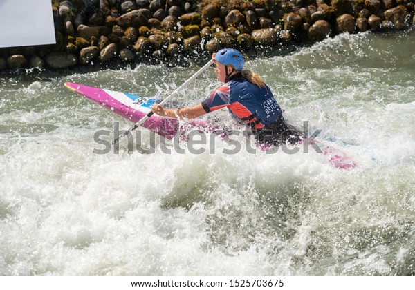 Great Britain canoe slalom athlete paddles through
white water