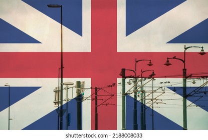 Great Britain, England Flag With Tram Connecting On Electric Line With Blue Sky As Background, Electric Railway Train And Power Supply Lines, Cables Connections And Metal Pole Overhead Catenary Wire