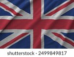 Great britain flag depicted on folded wavy fabric of old cloth close up